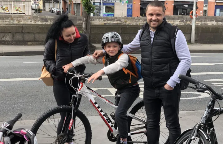 Another happy child receiving a bike.